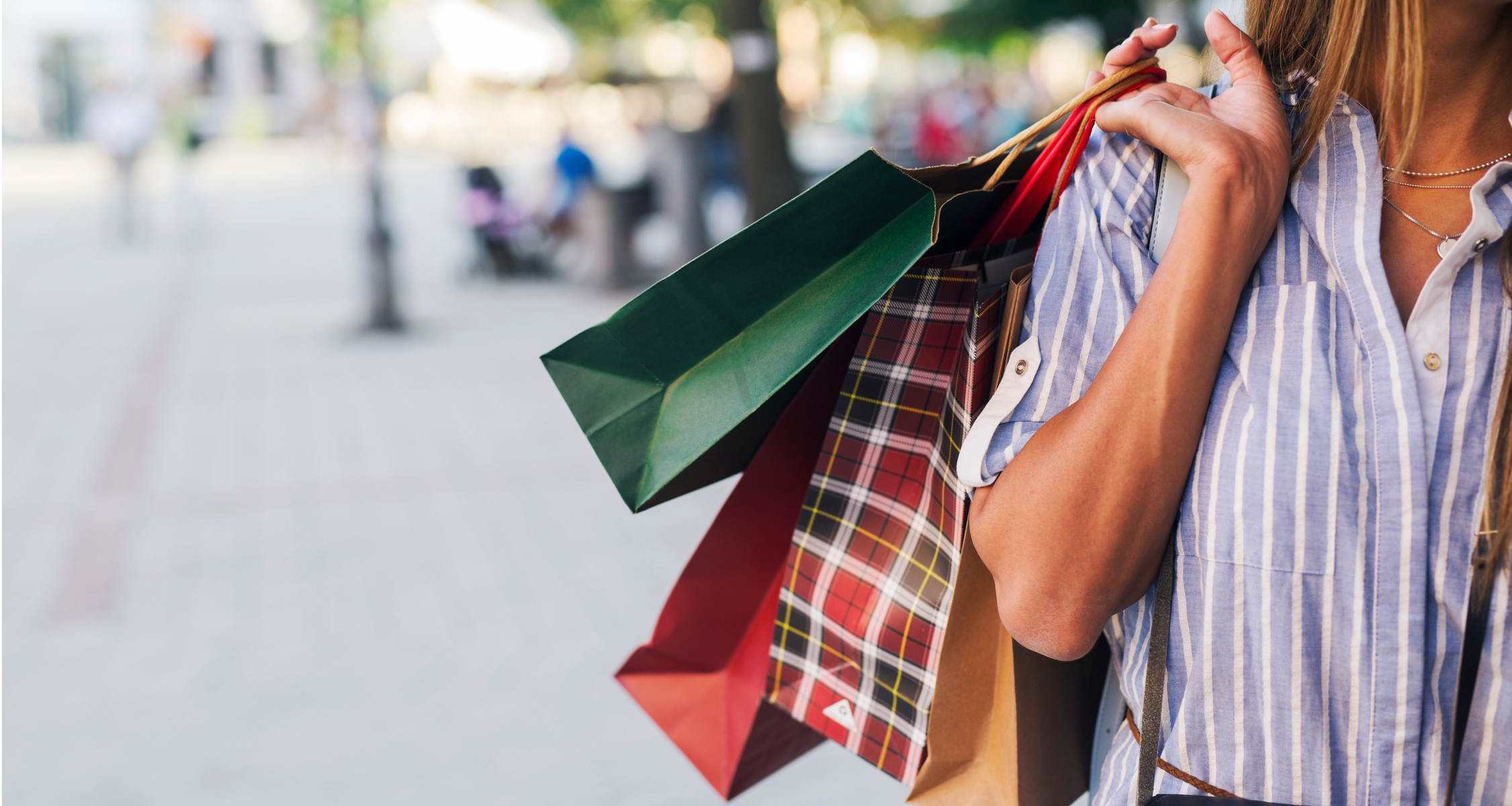 A woman holding many shopping bags