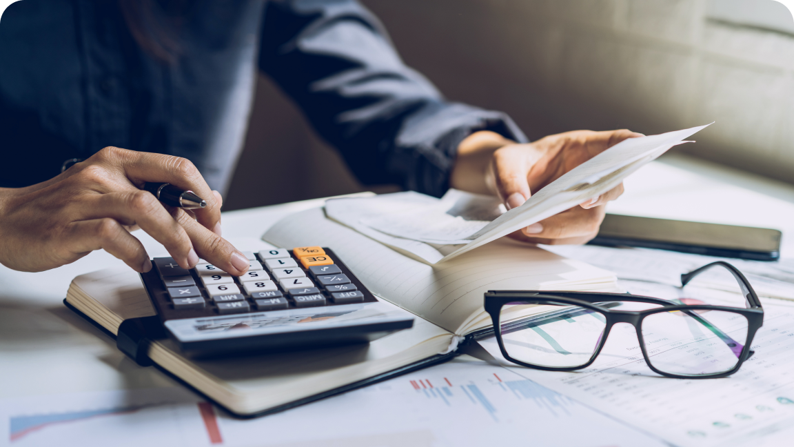 a person tapping a key on a calculator