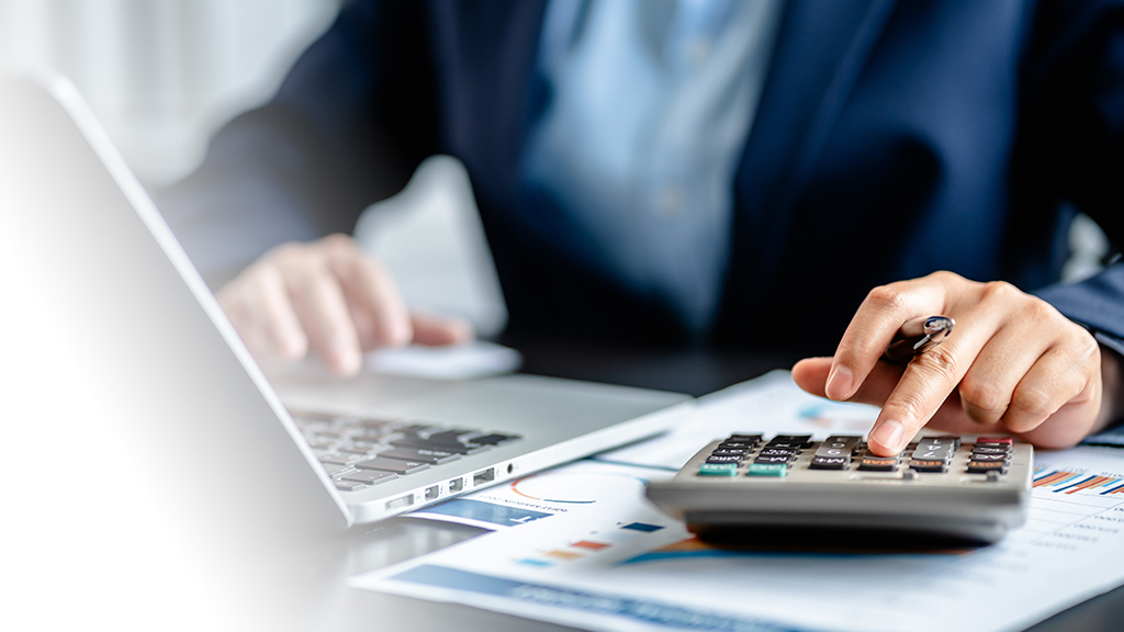 Man using calculator to work out savings