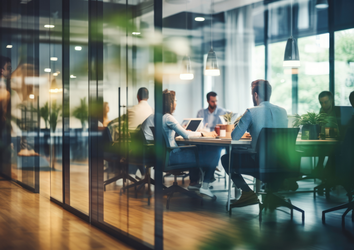 a blurred background image of an office meeting