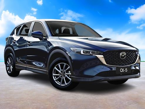 Blue Mazda on a dry landscape