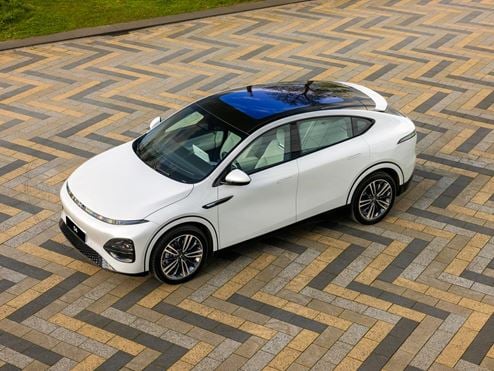 Full view of a white car on a driveway