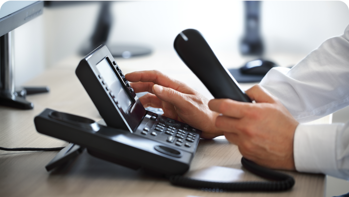 Someone dialing a number on a landline