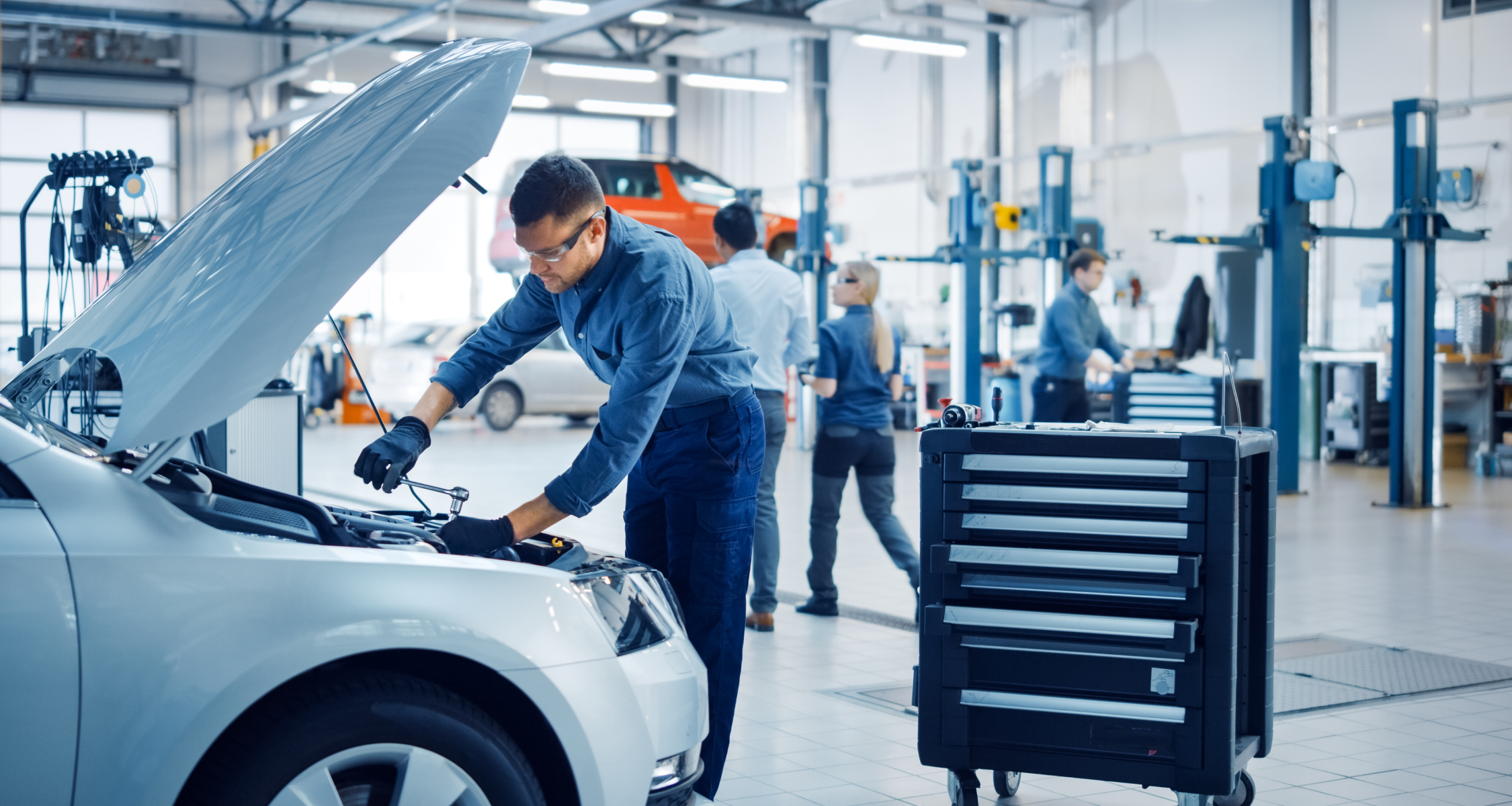 A mechanic inspecting a car