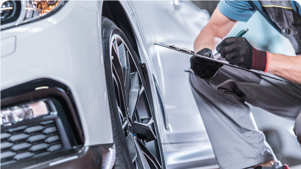 Closeup of someone inspecting car wheels