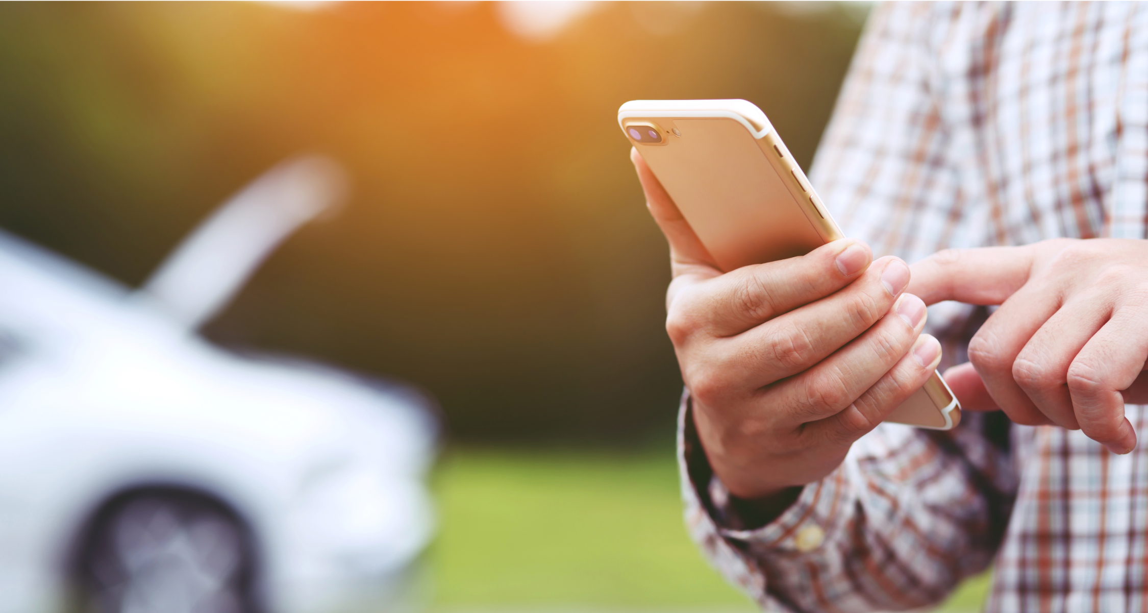 Someone using their phone to call roadside assist