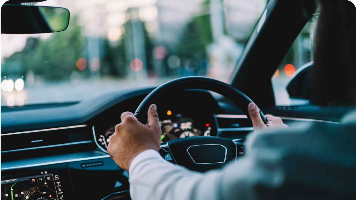 Closeup of a man driving a car in the city