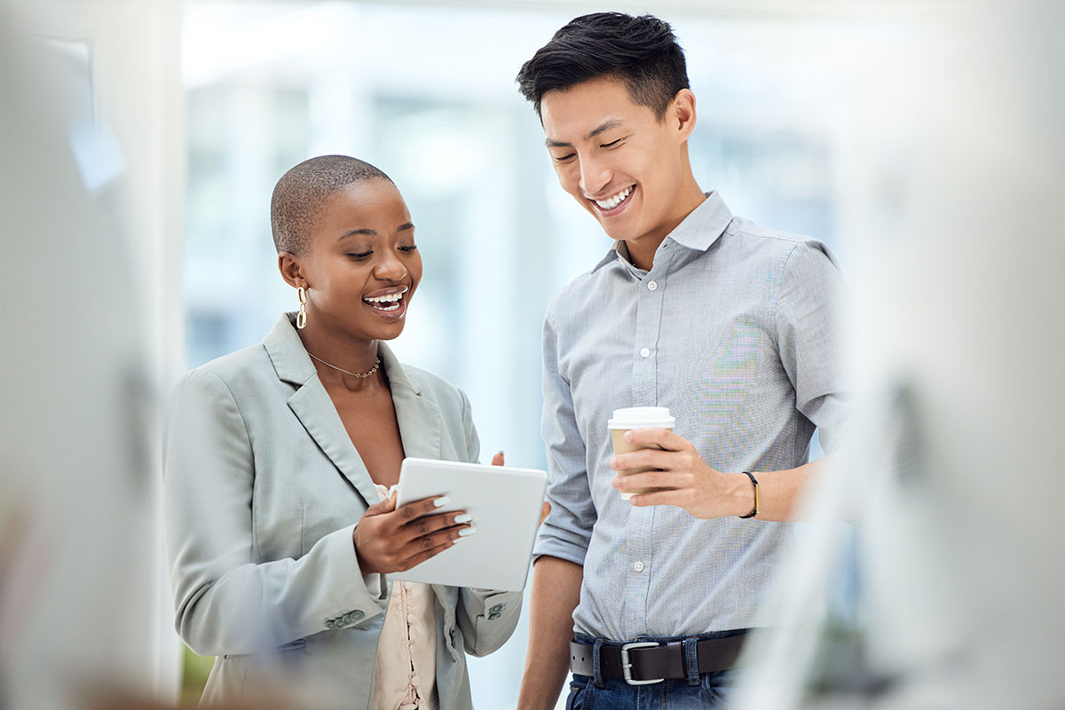 A man and a woman are discussing something in an office
